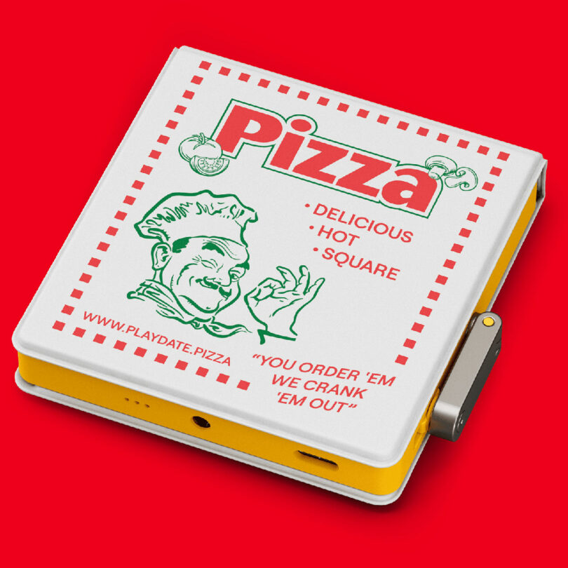 A white, square device resembling a pizza box with "Pizza" branding, red text, and a cartoon chef, placed on a red background. The device has a side crank.
