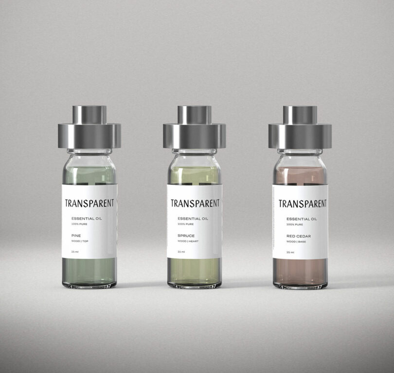Three glass bottles of essential oil labeled Pine, Spruce, and Red Cedar stand side by side against a plain gray background—perfect for use in your aroma diffuser. Each bottle features a silver cap and a crisp white label.