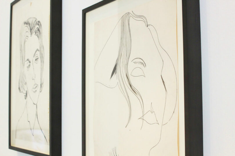 En una pared blanca se muestran dos dibujos lineales minimalistas enmarcados de rostros abstractos, lo que le da una sensación moderna que encaja perfectamente con la tendencia del arte sin marco de 2025.