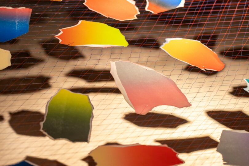 Formas de papel coloridas cuelgan de cuerdas en el interior. 