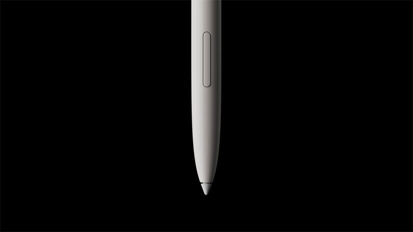 A close-up view of a white stylus pen, designed by Fuseproject, vertically positioned against a solid black background.