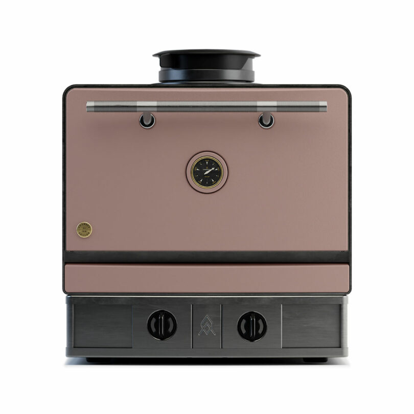 Front view of the Emberhaus modern, box-shaped pink and black kitchen appliance featuring a central dial, two lower knobs, and a top handle.