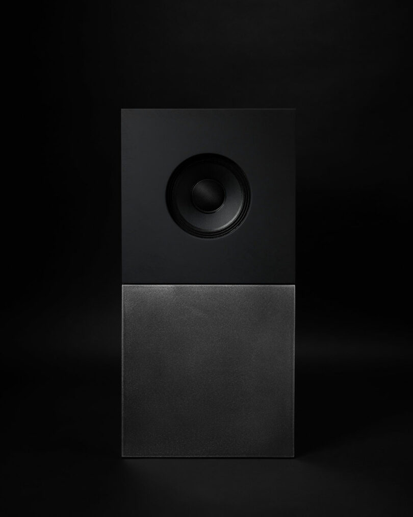 A single black speaker with a square design is centered against a dark background, showcasing the sleek aesthetics of Studio D.A and Nocs' debut—the Braque stereo system.