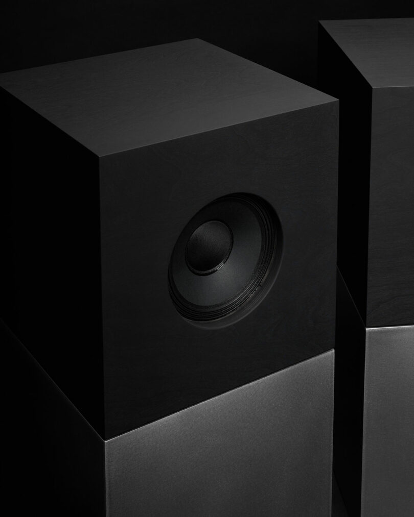 Studio D.A and Nocs debut the Braque stereo system—a black, minimalist speaker with a visible circular driver, set against a dark background.