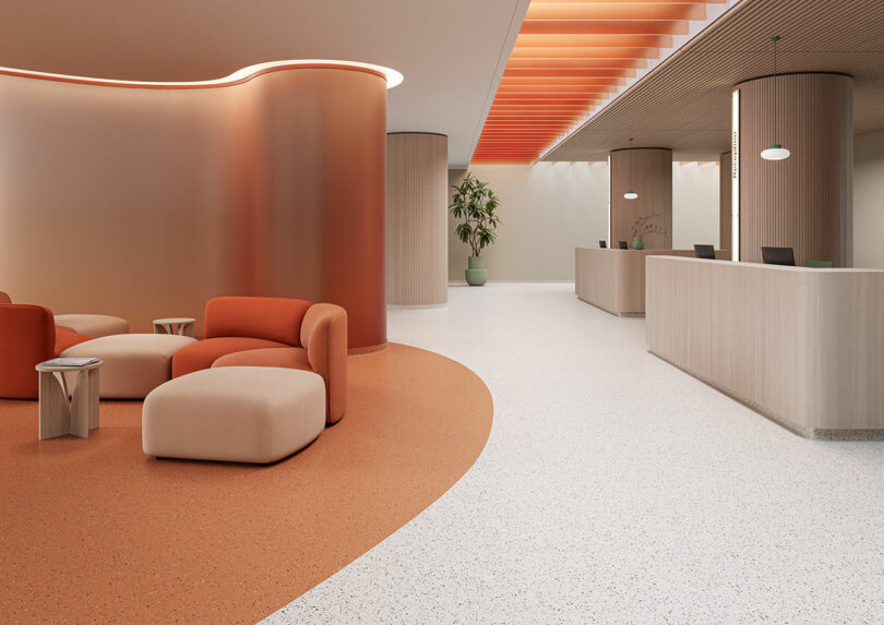 Modern lobby with curved orange seating area, beige ottomans, a Tarkett reception desk, potted plant, and orange ceiling accents. The space is brightly lit with smooth, clean surfaces.