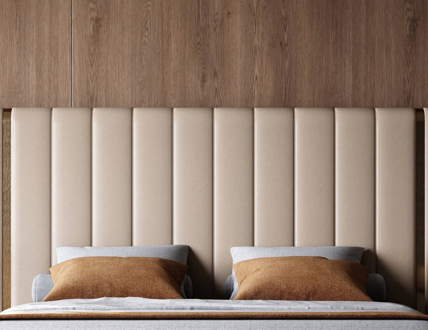 A beige vertical-channel tufted headboard against a wood-paneled wall, with two grey pillows and two brown accent pillows on the bed.