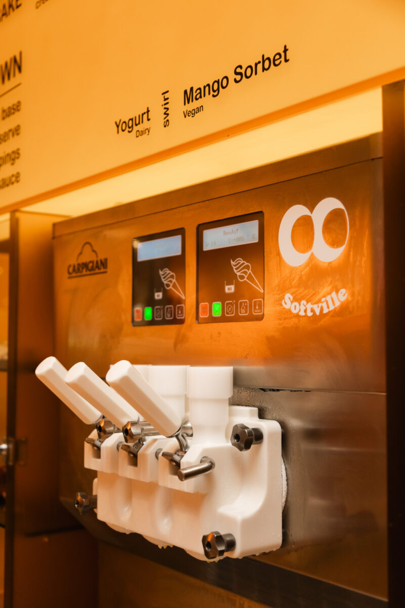 A Softville NYC soft-serve ice cream machine with digital displays labeled Yogurt and Mango Sorbet.