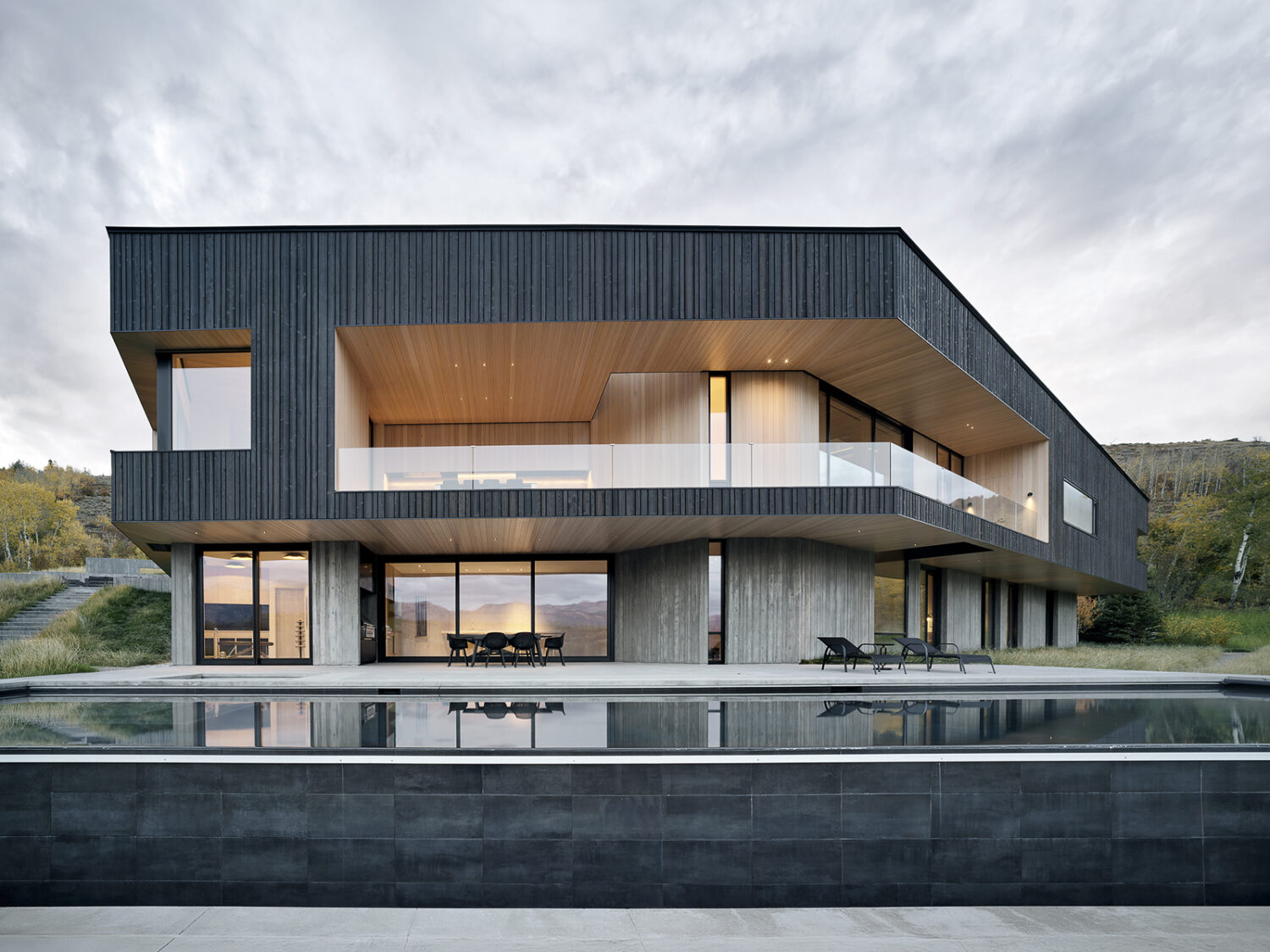 A Boomerang-Shaped Home Cantilevers Over the Wyoming Landscape