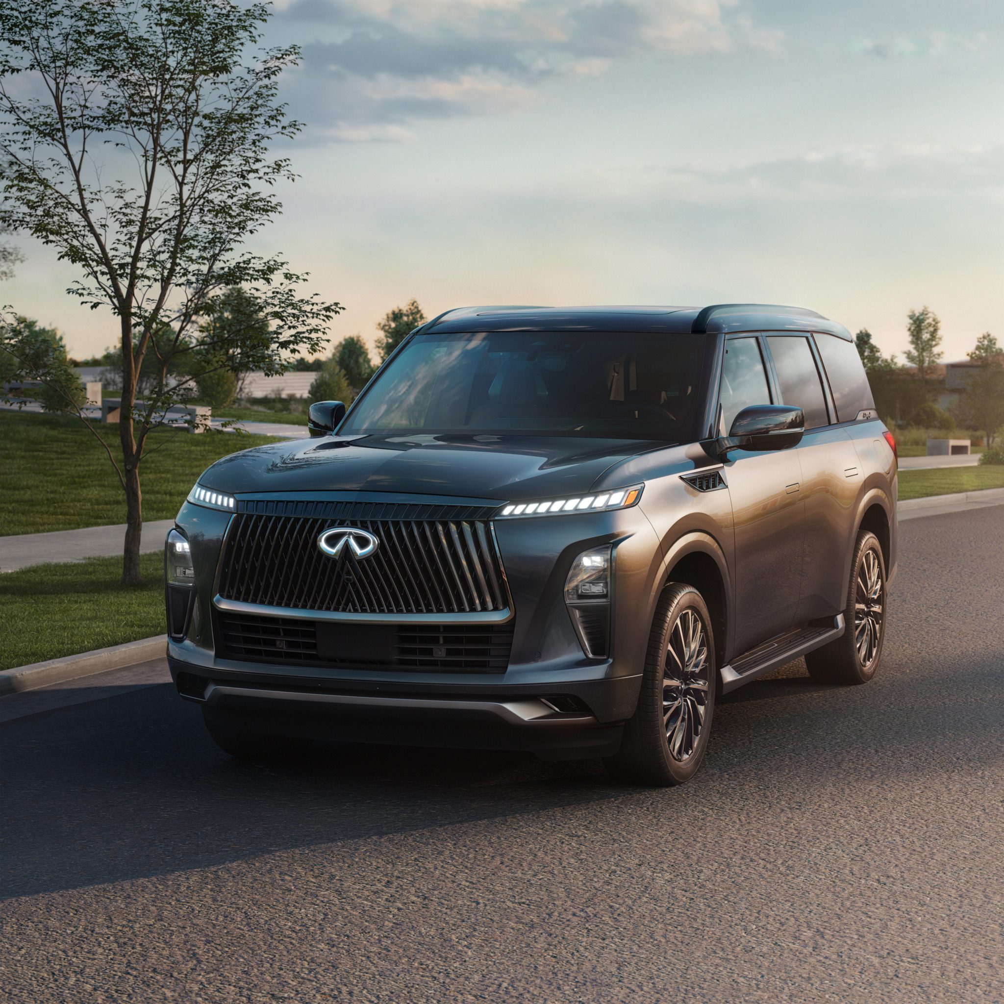 Dark grey Infiniti SUV parked on an asphalt road.