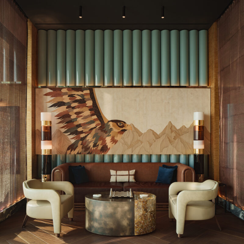 A seating area with a brown leather sofa, two cream-colored armchairs, and a round coffee table featuring a chessboard, centered in front of a wall mural of a flying hawk and mountains.