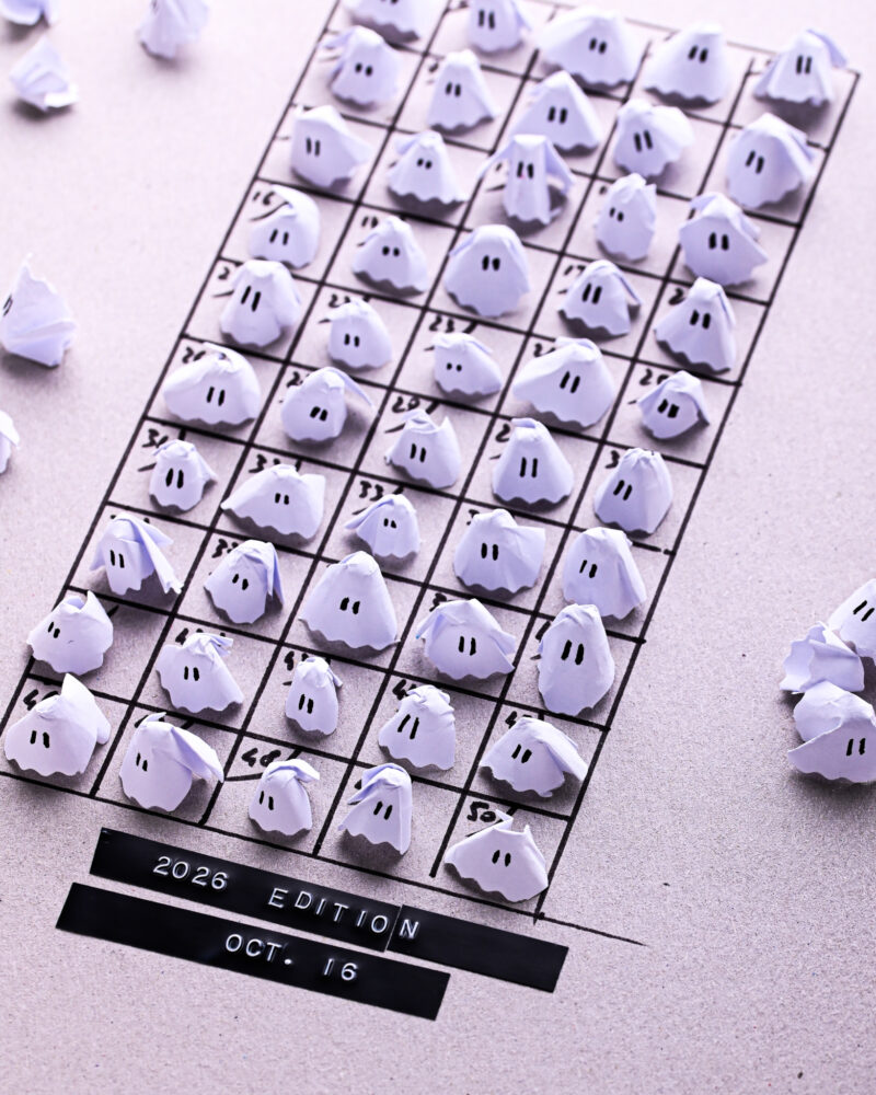 An October 2026 calendar grid featuring 50 small paper phantoms, with one ghost placed on each date.